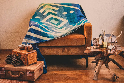 Picture of blue alpaca blanket in a boho style lounge